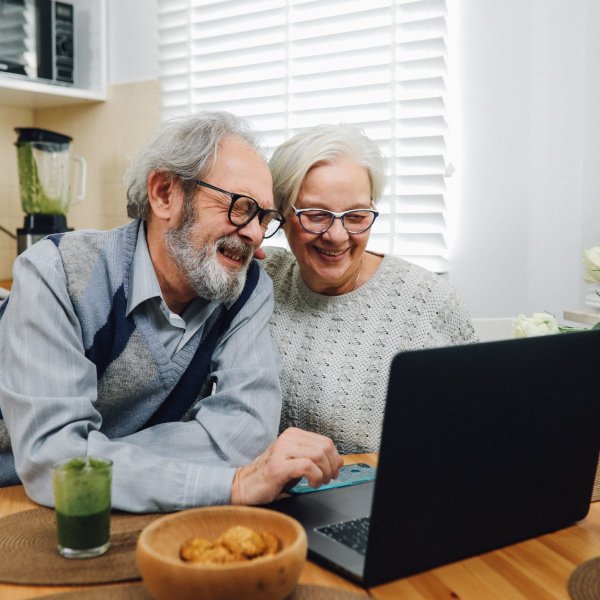 happy senior couple with a laptop